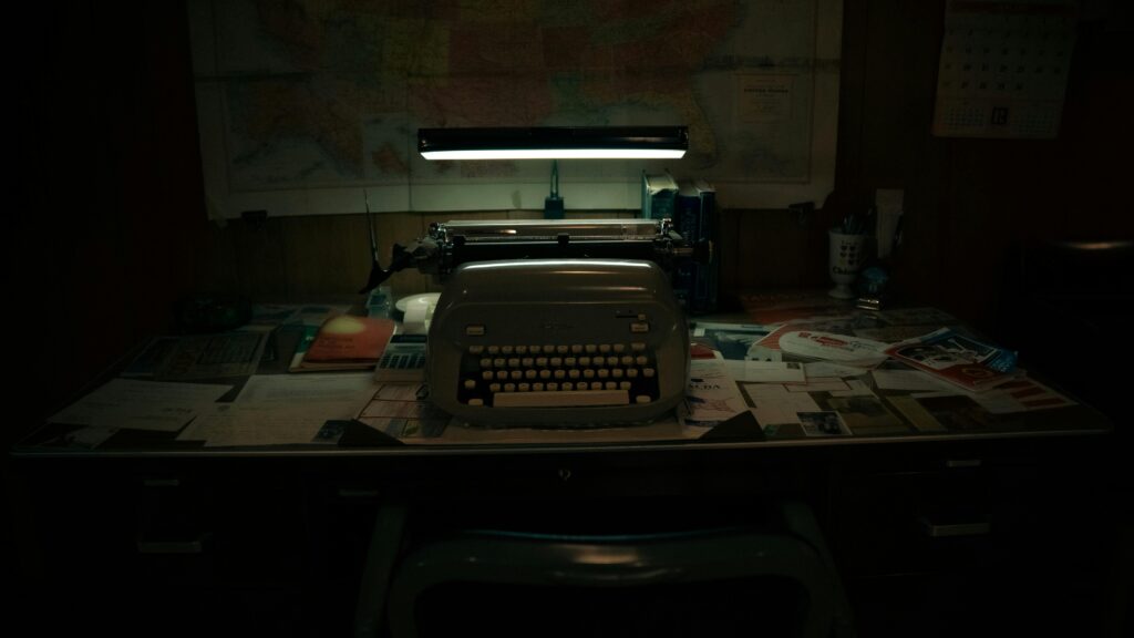Vintage typewriter on cluttered desk.